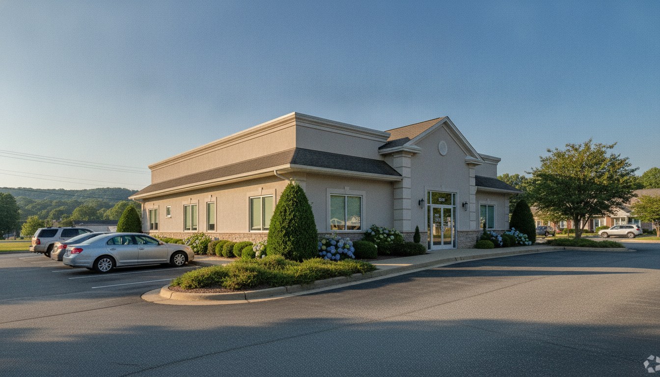 Daylight photograph of a tidy West Knoxville medical office exterior with landscaping under a clear sky